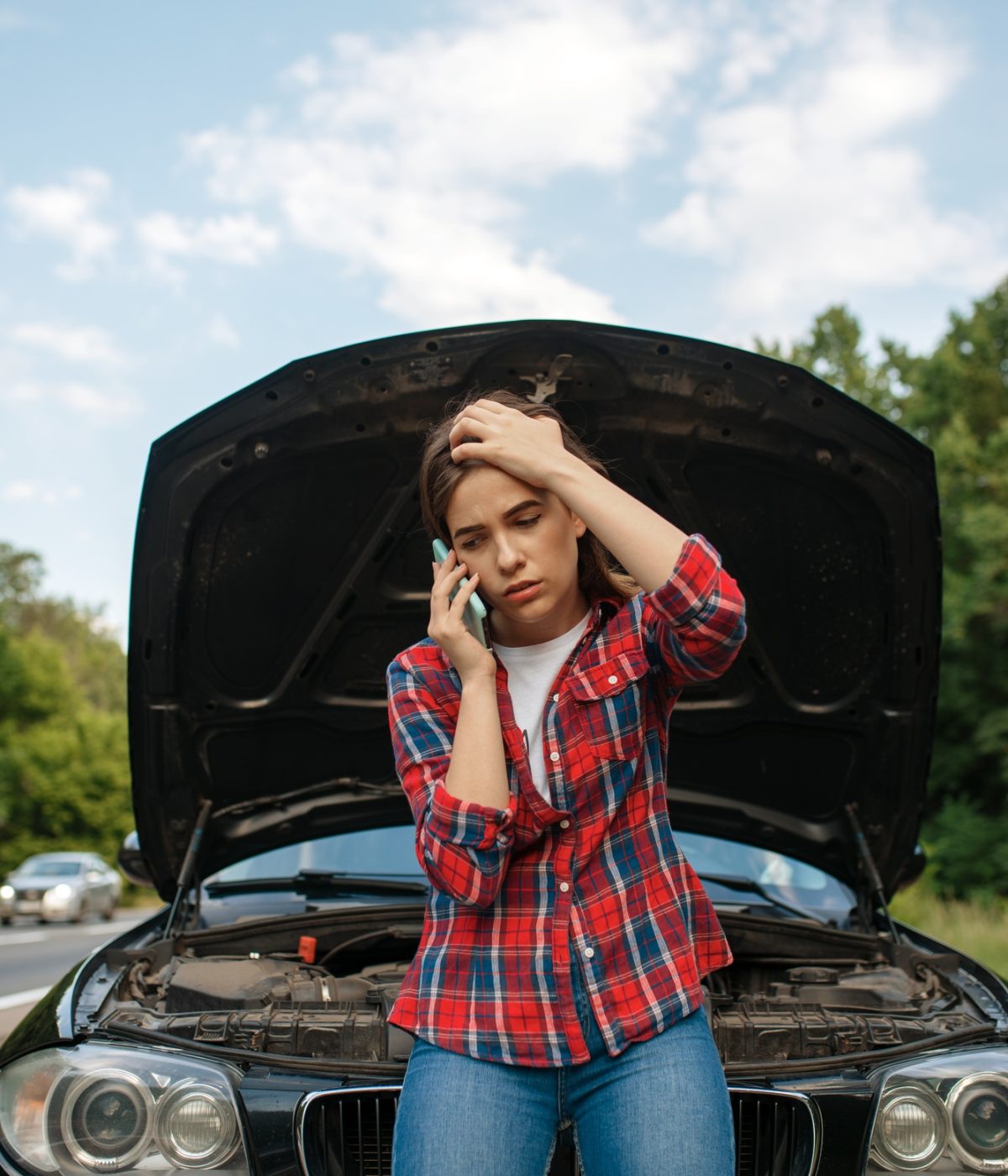 Woman calling a tow truck on road, car breakdown